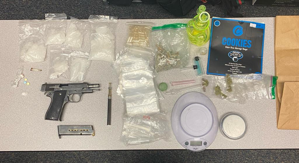 photo of drugs and firearm on a table