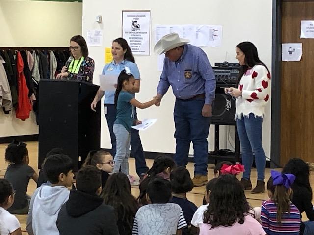 Little girl shaking hands with Sheriff