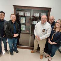 people standing by the cabinet containing the K9 memorials