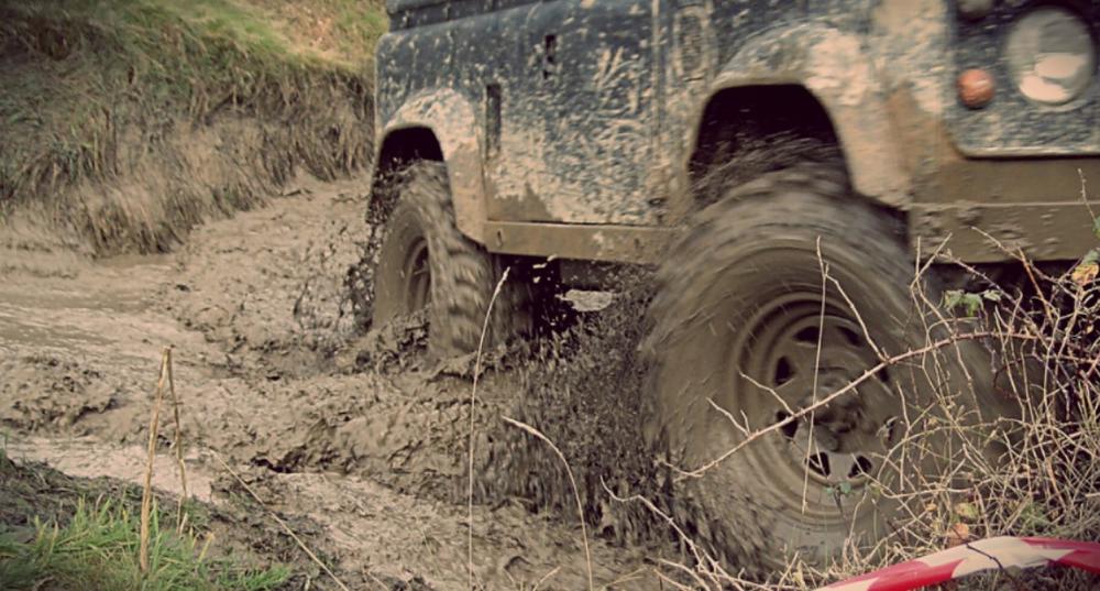 photo of vehicle driving in mud