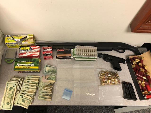 photo of drugs, money, guns on table