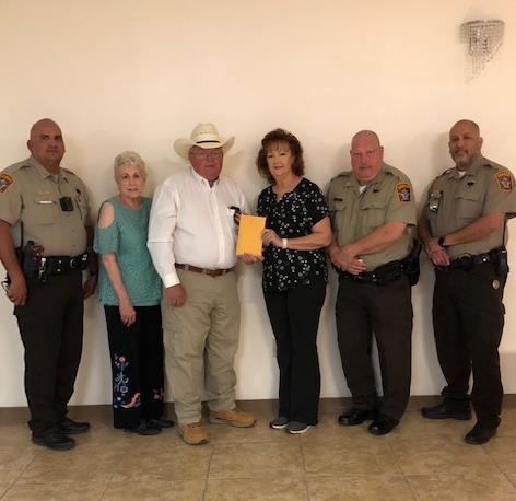 Photo of Sheriff giving money