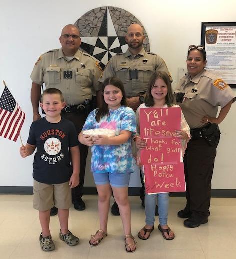 photo of children and officers with candy and cards