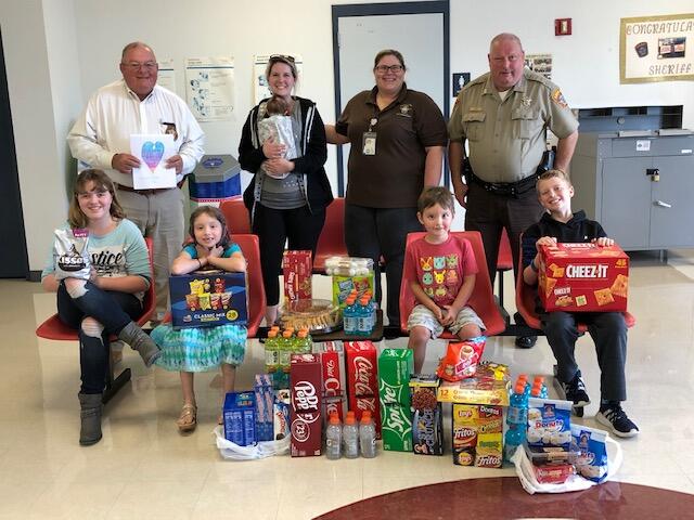 Photo of several people and donated items to SO