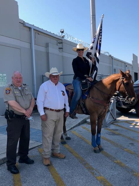 photo of horse rider and flag with Sheriff