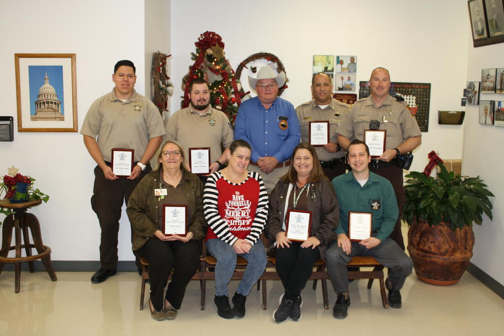 photo of employees holding their plaques